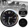 A close-up view of a stick-on car clock with a waterproof display showing the time on a black background.