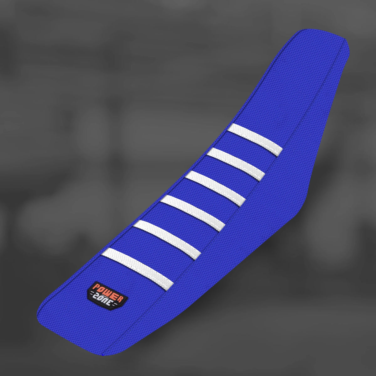 A blue motorcycle seat cover with white stripes and a Power Zone logo on the side.