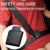 A close-up view of a black PU leather car seat belt adjuster strap on a red shirt.