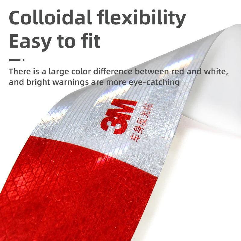 Close-up of a red and white high-visibility reflective decal showing the 3M logo on a flexible material.