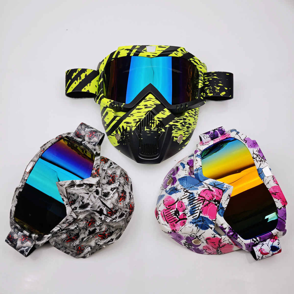 A set of tactical full face motorcycle goggles featuring a yellow and black camouflage pattern and colored lenses.