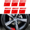 Red reflective safety stickers applied to a black alloy wheel.