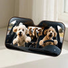 A dog-themed car windshield sunshade featuring several golden retriever puppies inside the black protective frame.