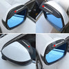 A clear blue universal car rearview mirror rain cover installed on a vehicle.