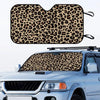 Leopard print car sunshade fitted onto the windshield of a silver truck.