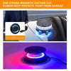 A close-up of a magnetic suction cup protecting paint on a car surface, illuminated by blue light.