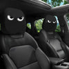 Black car seat headrest covers with a decorative pattern installed in a vehicle interior.