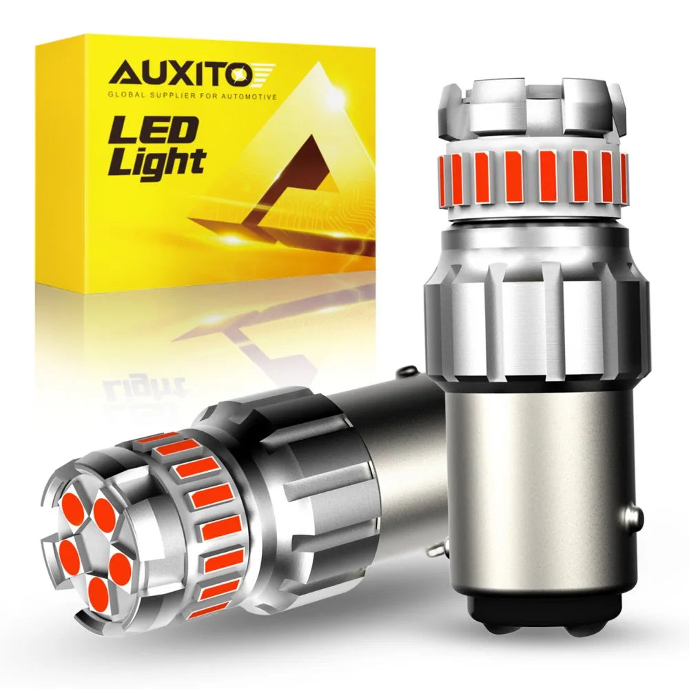 A silver LED light bulb assembly for automotive use shown next to its yellow packaging box.