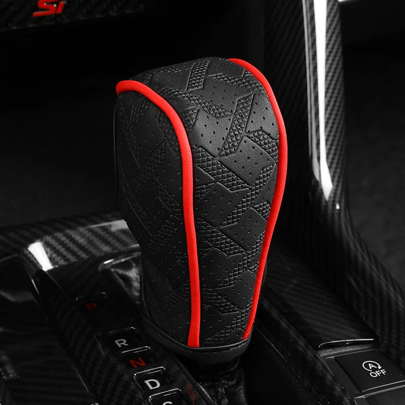 Black artificial leather handbrake cover with red stitching shown on a car interior component.