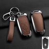 A brown leather strap attached to an aluminum alloy key fob cover for a Ford vehicle.