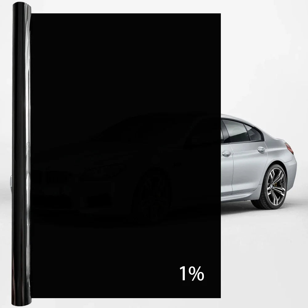 A close-up view of a black car window privacy film applied to a silver car.