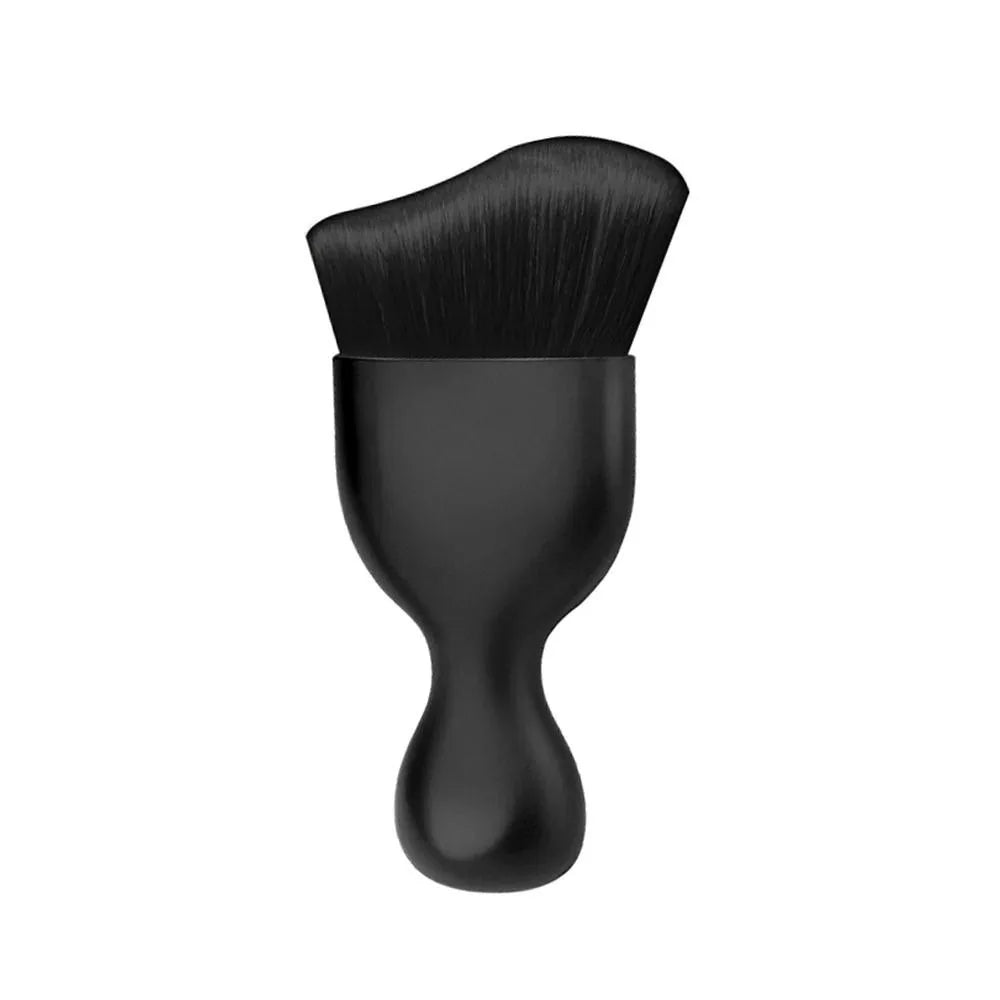 A black curved silicone brush with a dense, fine bristles for cleaning car interiors.