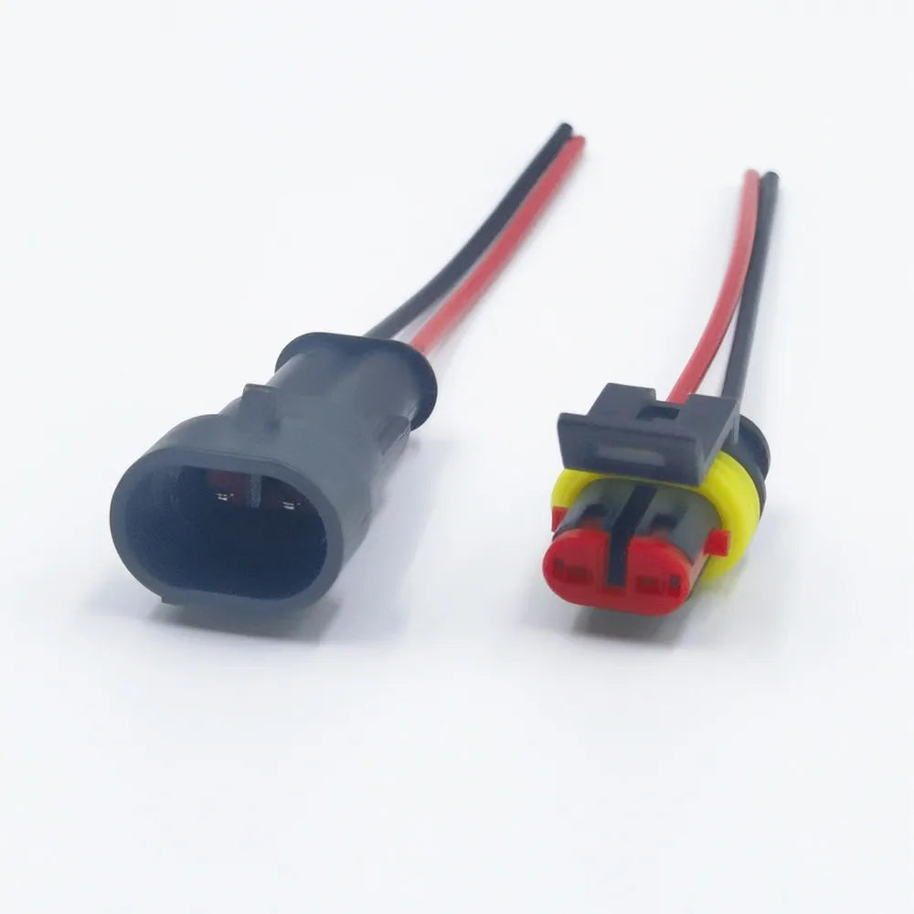 A waterproof electrical connector kit showing a gray plug with a red wire and a yellow connector piece.
