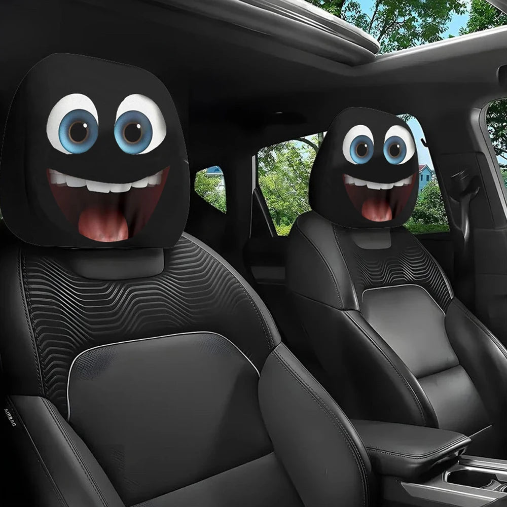 Two black car headrest covers with funny slanted eyes are shown inside a vehicle cabin.