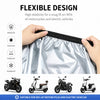 A hand is holding a flexible, waterproof silver cover designed for protecting motorcycles and electric vehicles.