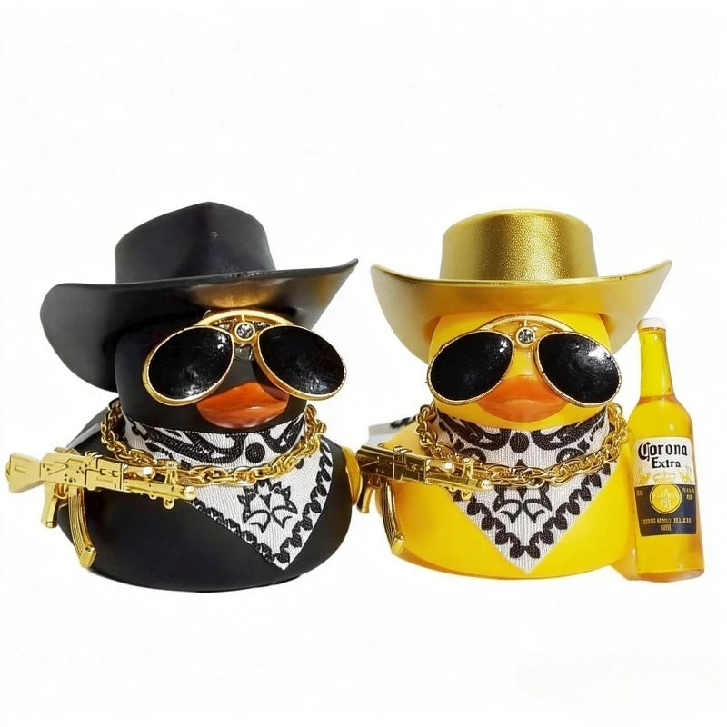 A pair of black and yellow rubber duck car ornaments with gold accents and a Corona Extra bottle.