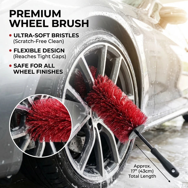 A close-up of a red premium wheel brush cleaning a car rim, showing ultra-soft bristles and flexible design.