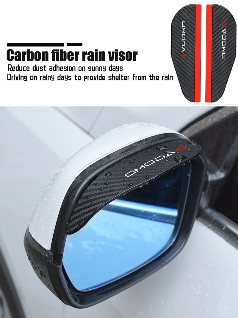 A close-up view of a black carbon fiber rain visor installed on a car's rearview mirror.