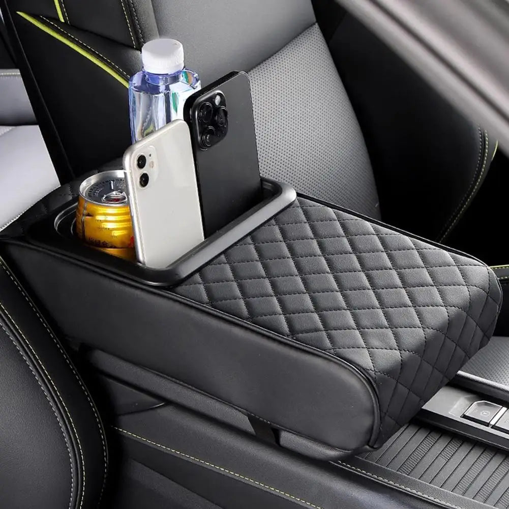 A black car armrest features a quilted cushion with an integrated cup holder for drinks and a smartphone.