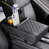 A black car armrest cushion features a quilted texture and holds a smartphone, water bottle, and a can.