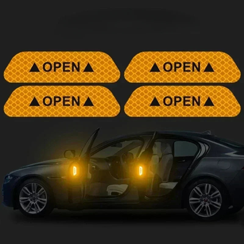 Four yellow warning decals with open triangle symbols displayed above a dark car.