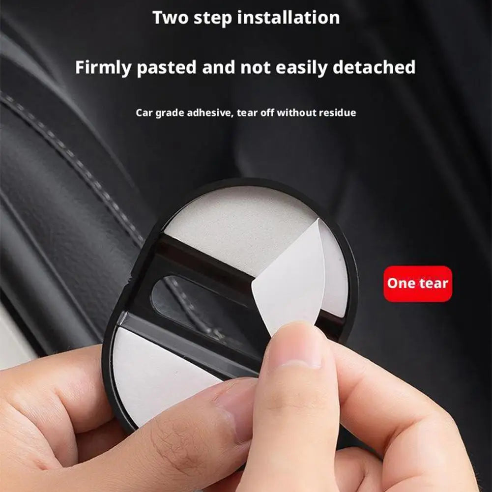 A hand is applying a two-step installation car grade adhesive to a protective cover for a car door lock.