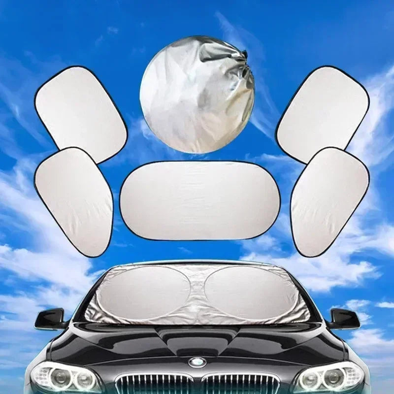 A set of six white car windshield sun shades is displayed above a black car's hood.