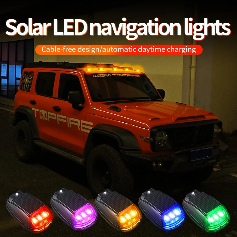 Orange Jeep truck equipped with solar LED navigation lights installed on the roof and front bumper.