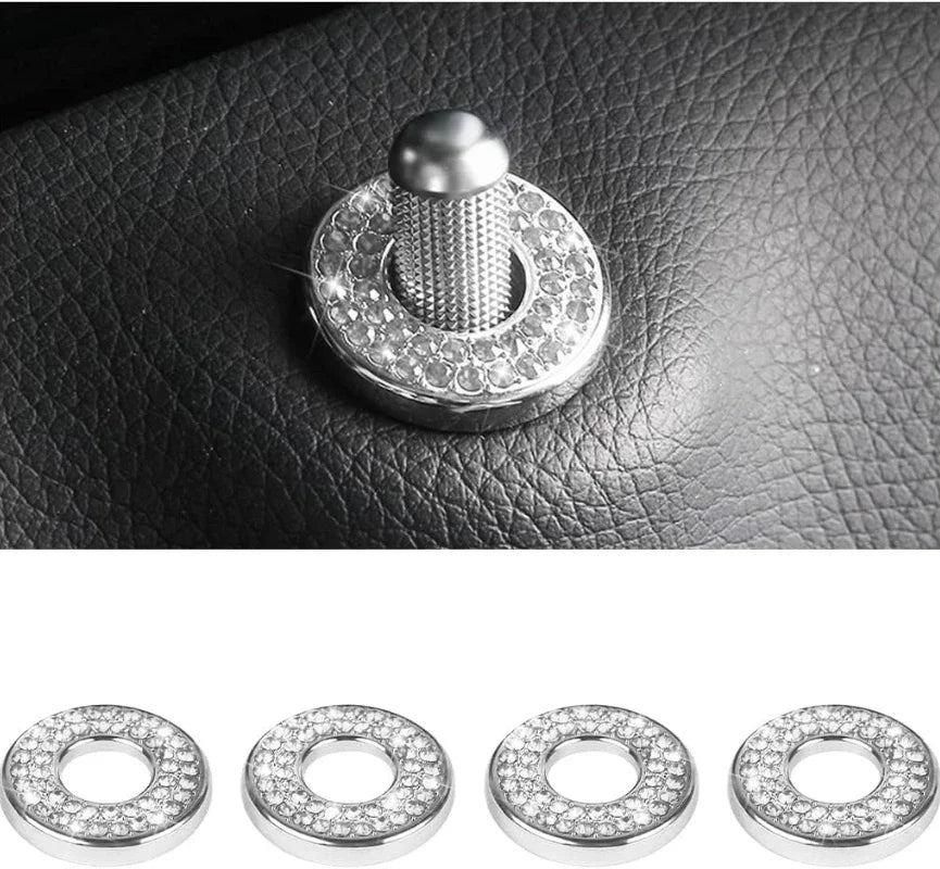 Four silver rhinestone door lock decorations displayed against a dark leather surface.