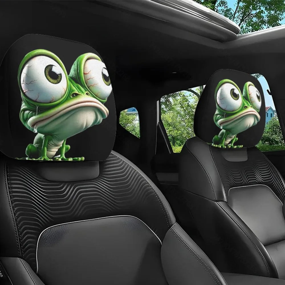 A pair of green frog-themed car seat headrest covers featuring cartoon frogs on a black car interior.