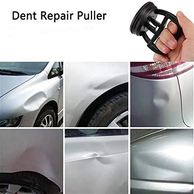 A hand is using a car dent repair puller with a suction cup to remove dents from a vehicle's body panel.