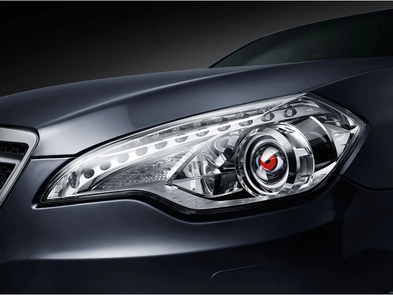 Close-up of a dark gray car's modern headlight assembly with clear lenses and internal reflectors.