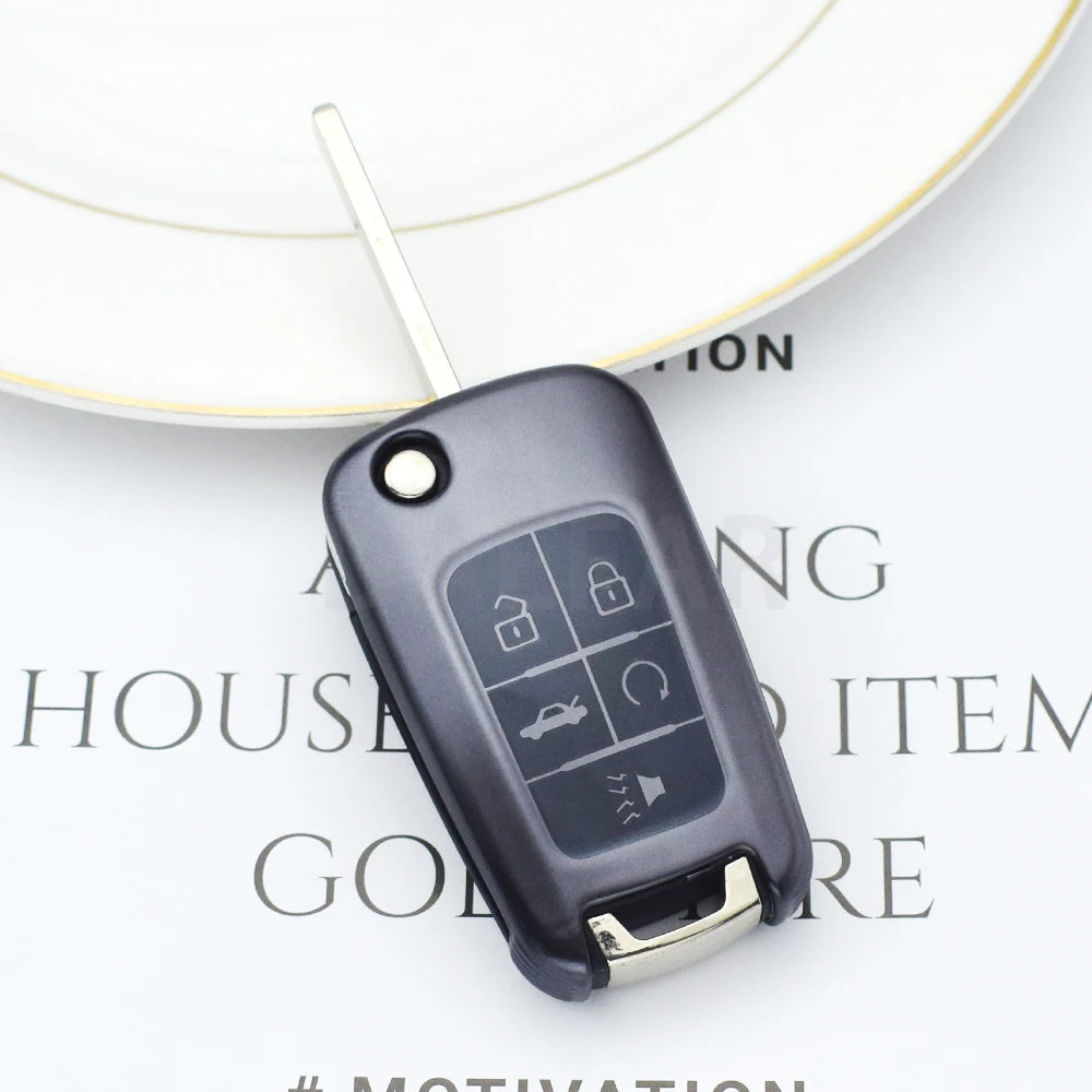 A black universal car key cover with lock and unlock buttons is shown resting on a white background.