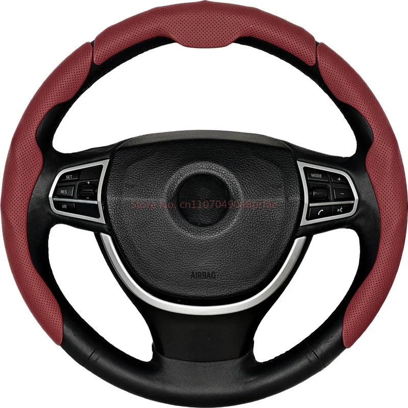 A black steering wheel with a red leather cover and controls.