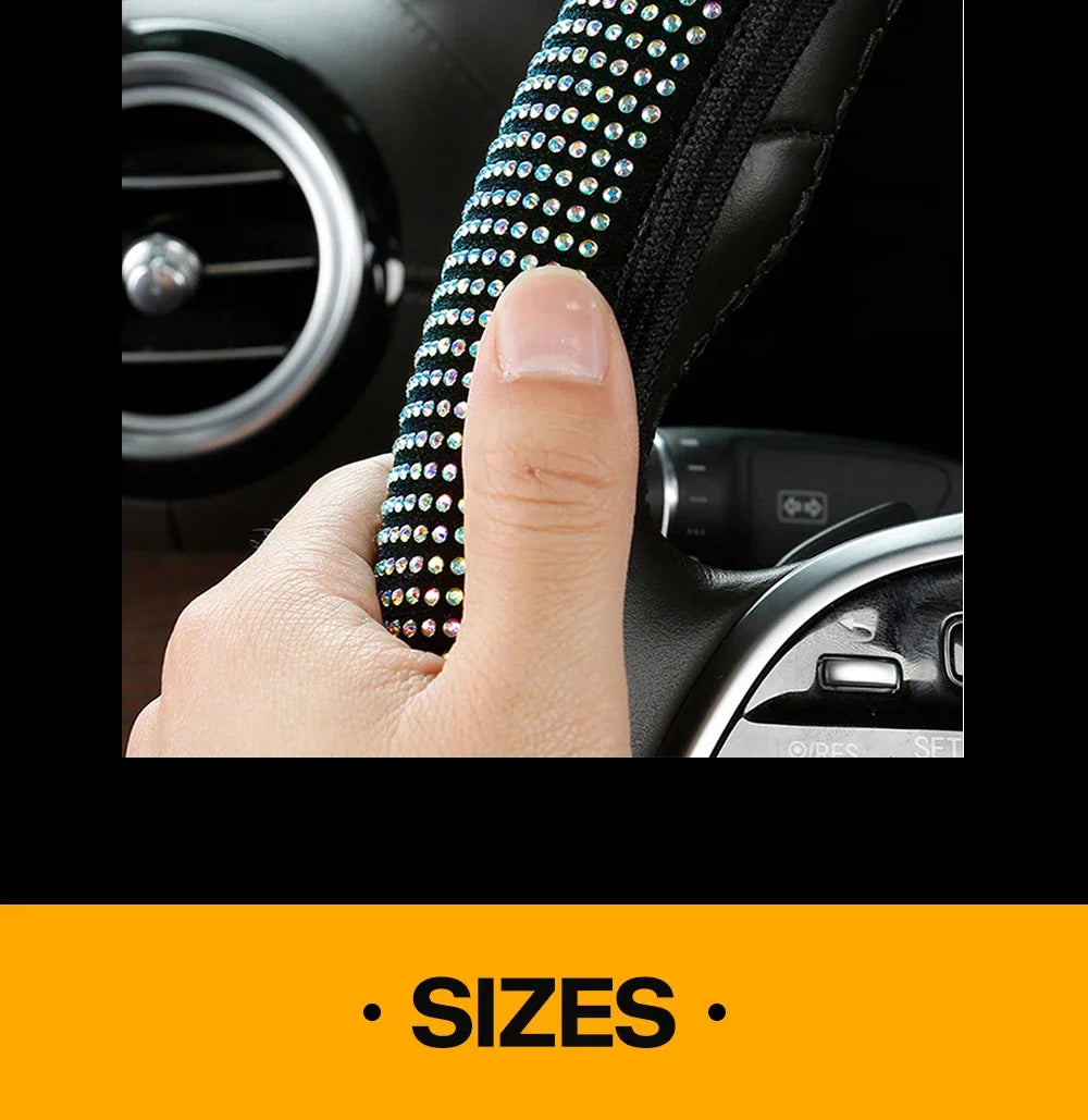 A hand is holding a black steering wheel cover adorned with crystal diamond rhinestones.