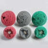 A set of four precision flap sanding wheels in shades of pink, gray, and green.