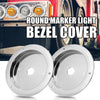 A pair of round marker light bezel covers for vehicle headlights.