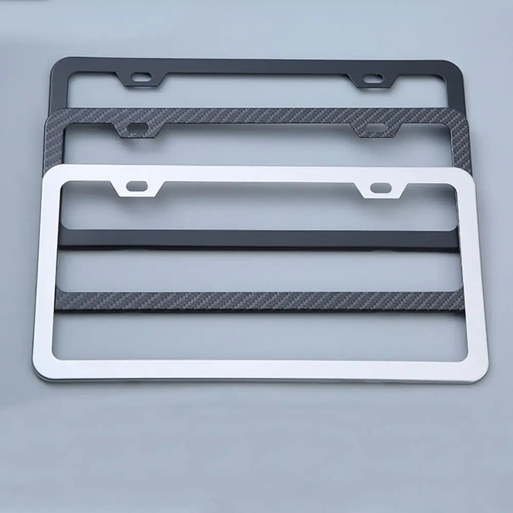 A set of three stainless steel car license plate frames in black and silver finishes.