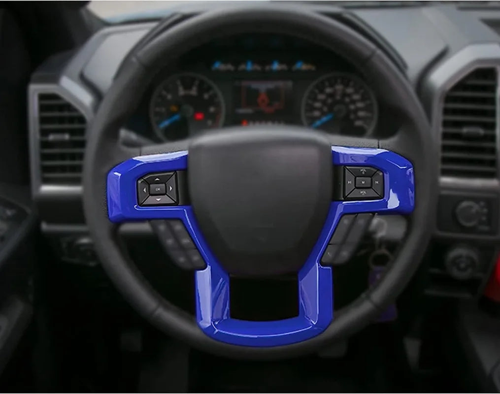 Close-up view of a black steering wheel with blue trim accents inside a truck cabin.