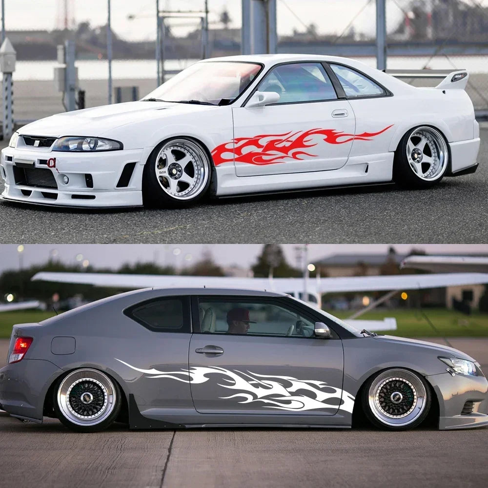 A white sports car features red flame vinyl decals on the side and a gray car has black flame graphics.