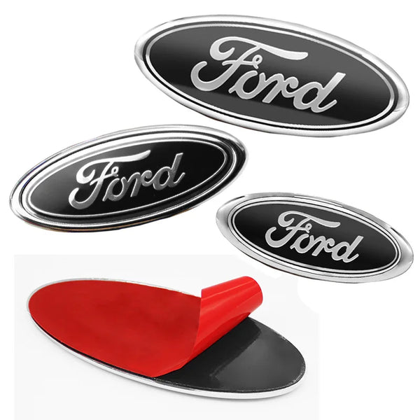 A set of Ford front hood emblems, including chrome badges and a red replacement piece.
