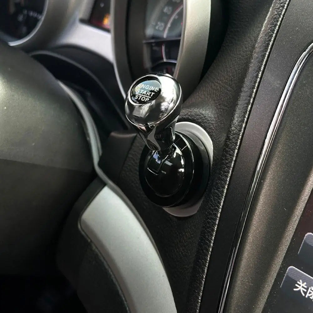 Close-up of an all-metal cylindrical car start stop button accessory mounted on a vehicle dashboard.