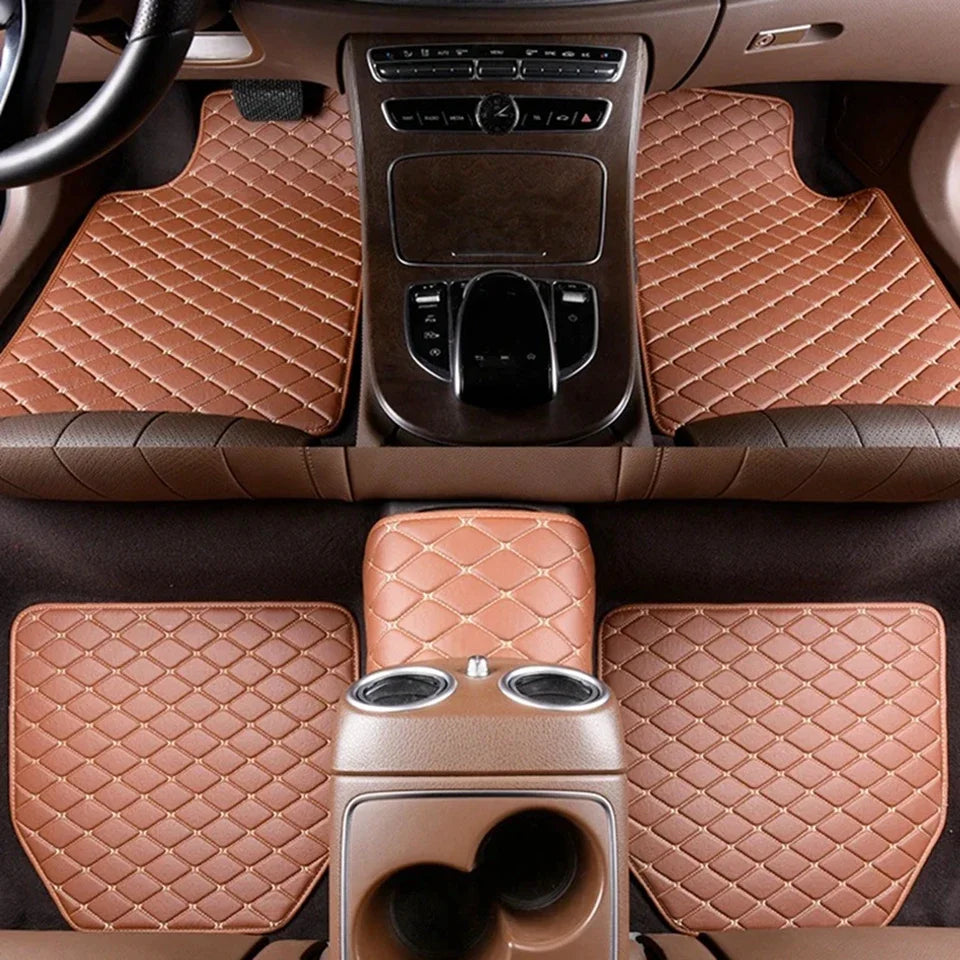A set of five brown quilted PU leather car floor mats with integrated speakers and controls installed in a vehicle cabin.
