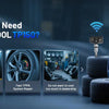 A blue professional OBD2 TPMS diagnostic scanner is shown with various tires and tools in a workshop setting.