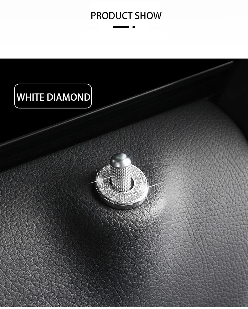 A close-up shot of a white diamond car door lock pin trim set resting on a dark leather surface.
