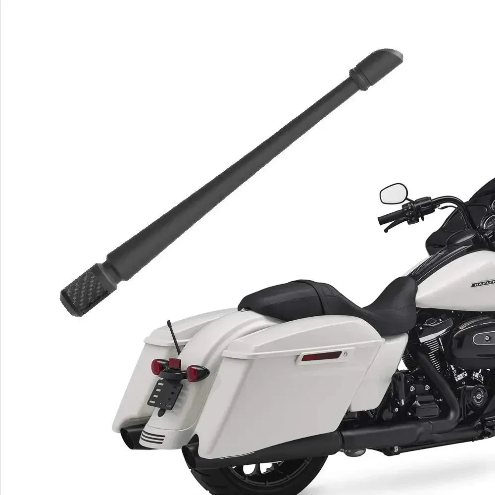 A black car radio aerial antenna kit is shown next to a white motorcycle.