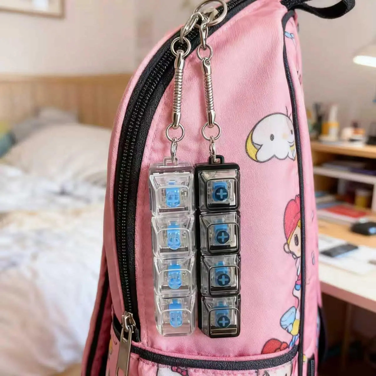 Pink backpack with a zipper pouch containing multiple clear LED keyboard keychains