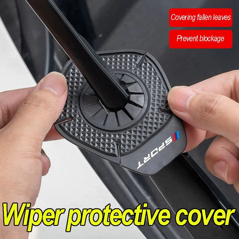 A black wiper protective cover is shown being installed on a car windshield, designed to prevent blockage and cover fallen le