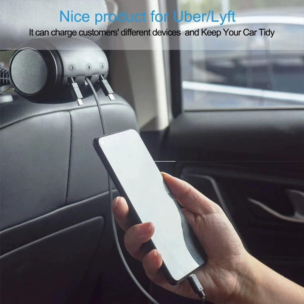 A hand holds a smartphone plugged into a retractable car headrest charging cable for device charging.