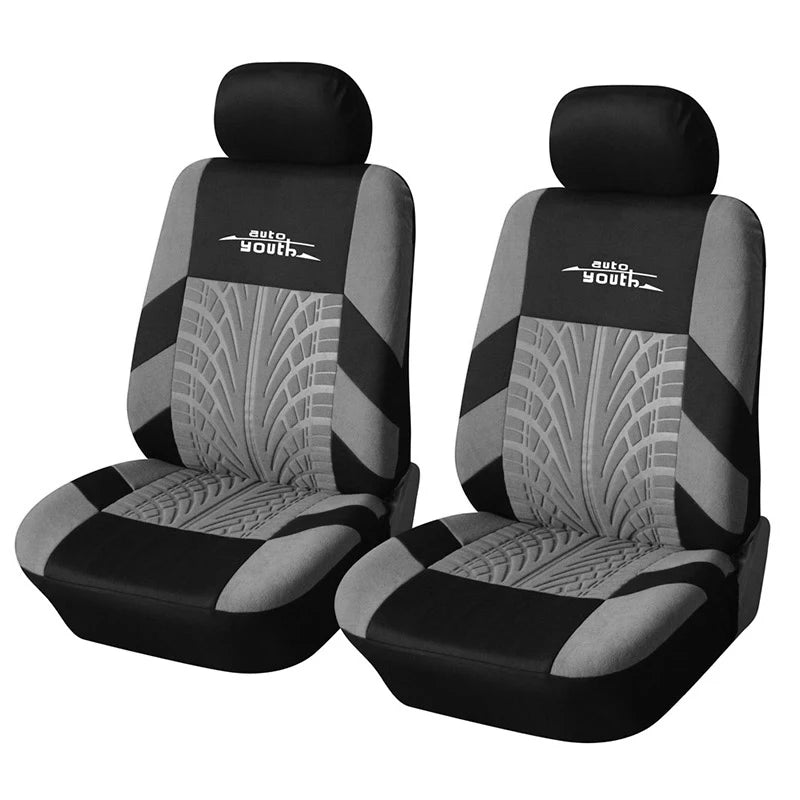 A pair of black car seat covers with gray accents and auto youth branding.
